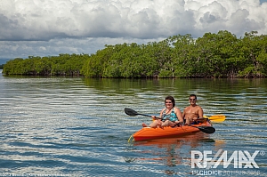 Couple Kayaking Near Placencia Caye